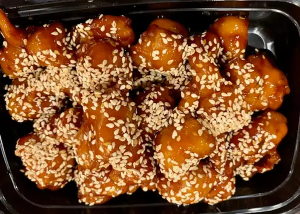 Sesame-Coated Glazed Fried Bites in Takeout Box